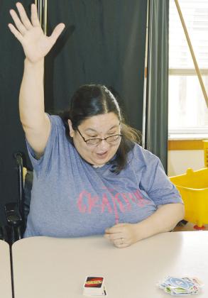 Martha Zamora just played her last card and won during Uno and Milkshakes at River Valley Therapy Center. CDN | Christian Jacobsen