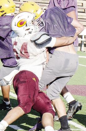 Clinton’s Colton Pool, left, wraps up the Anadarko ball carrier in the Tornado Bowl during the Red Tornadoes’ scrimmage Friday. CDN |Sam Goodwyn