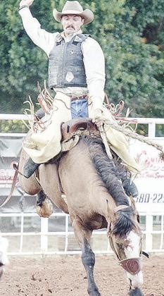 Everrett Blackburn holds on tight as he performs in the saddle bronc event. CDN | Sam Goodwyn