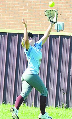 Laney Anderson reaches out to catch the ball in an outfield drill during practice Tuesday. CDN | Sam Goodwyn