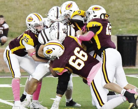 No. 25 Gavin Evans, No. 66 Andre Lime, No. 15 Dyson Moss and No. 7 Easten Powell take down the Elk City ball carrier during Clinton’s win Friday over the Elks in the Tornado Bowl. CDN |John Kinsey
