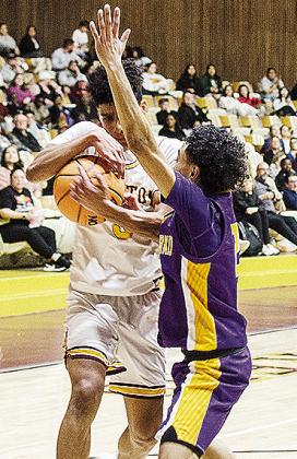 No. 3 Titan Malone fights through an Anadarko defender as he makes his way to the basket during Clinton’s game against the Warriors Tuesday in the Tornado