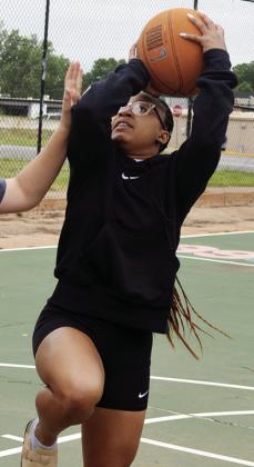 Ale-Jia Lacy shoots a contested shot Tuesday afternoon at the McLain Rogers Park basketball court. CDN | Christian Jacobson