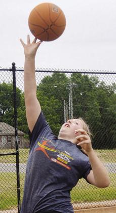 Lexie Deatherage jumps to catch the ball being passed to her Tuesday afternoon at the McLain Rogers Park basketball court. CDN | Christian Jacobson