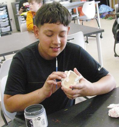 Ethan Quezada is in class making a big mouth art sculpture at Clinton Middle School. CDN | Christian Jacobsen