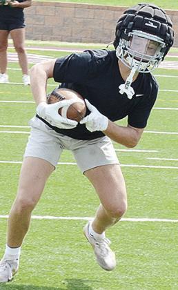 Clinton’s Dyson Moss steadies his feet after catching the ball during the first day of practice Monday in the Tornado Bowl. CDN | Sam Goodwyn