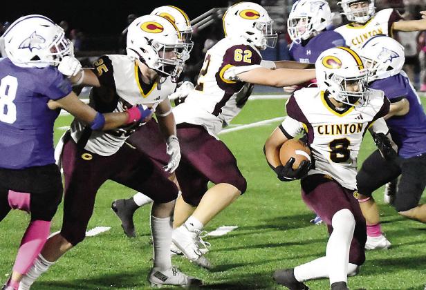 Clinton’s No. 8 Jaden Potter carries the ball as No. 25 Gavin Evans and No. 62 Layne Spitz provide blocks for him during the Red Tornadoes’ road game Friday against Bridge Creek. CDN | John Kinsey