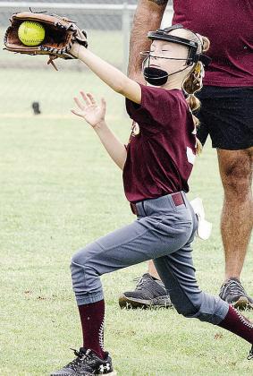 Vivien Salinas catches the ball prior to Clinton’s softball game in the OK Kids 8U Softball State Tournament. CDN |Sam Goodwyn