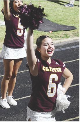 Tatum Shackelford waves her pompom in the air as she gets the crowd loud Thursday during Clinton’s road win over the Woodward Boomers. CDN | Sam Goodwyn