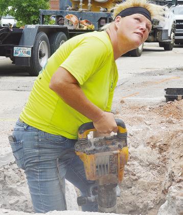 Crystal Rushing drills underground to install new fiber optic lines on Ninth Street between Gary Boulevard and Frisco Avenue Thursday afternoon. CDN | Micah Ashcraft