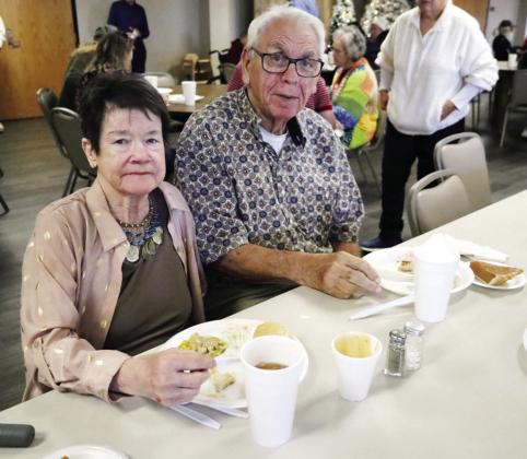 Charla Wedel, left, and Russell DeVries enjoy a meal at the annual Cornerstone Church Thanksgiving Feed.