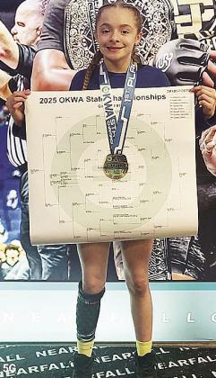 Clinton’s Madison Lopez shows off her medal and bracket after winning her second straight state title win in wrestling. CDN | Courtesy Photo