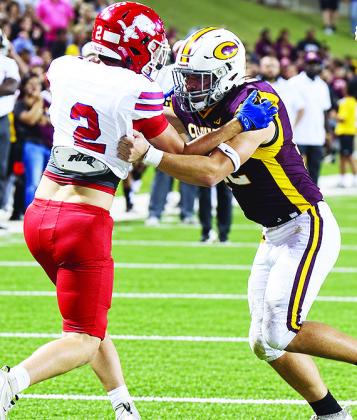 Clinton’s Benton Bridgeman blocks a Durant defender during the Red Tornadoes’ come-from-behind win over the Lions last week in the Tornado Bowl. CDN | John Kinsey