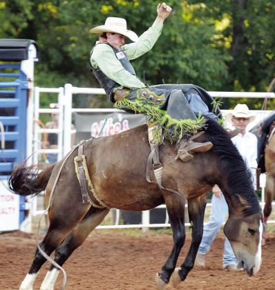 Austin Stratman holds on tight as he rides bareback during last year’s Clinton Rodeo. CDN | Sam Goodwyn