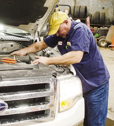 Nate Burnett works on one of the vans at the Clinton Bus Barn. CDN | Sam Goodwyn