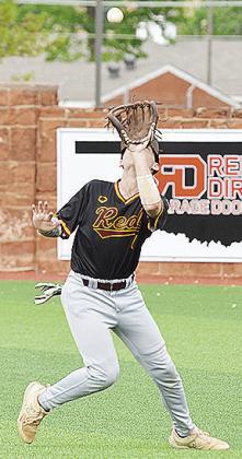 Clinton’s Chase Ray focuses on the ball as he attempts to catch it during the Reds’ game against the Elks. CDN | Sam Goodwyn