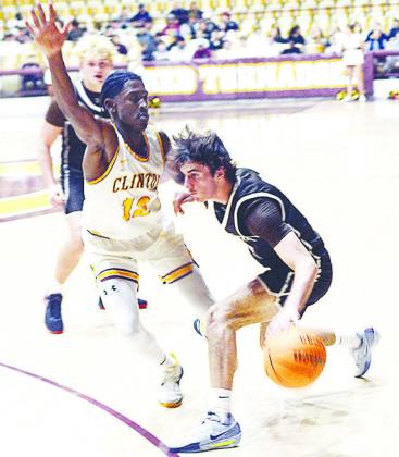Clinton’s Atticus Thompson defends against Elk City’s Cole Allen Buie during the Reds’ home win over the Elks Tuesday in the Tornado Dome. CDN | Sam Goodwyn