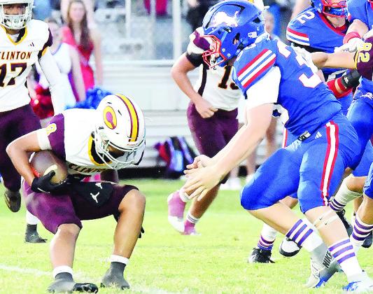 Clinton’s Jaden Potter, left, looks to avoid a tackle during the Red Tornadoes’ road game Friday against Chandler. CDN | John Kinsey
