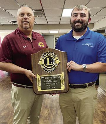 Tyler Freeburg, right, is presented a plaque recognizing his tenure as president of the Clinton Noon Lions Club from Brent Caldwell, current president of the civic group. CDN | Staff Photo