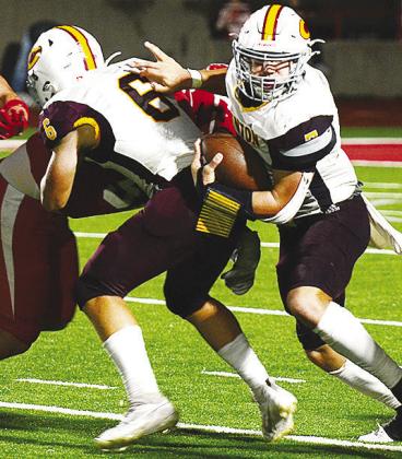 CDN |Micah Ashcraft Clinton’s No. 6 Benton Bridgeman blocks for sophomore quarterback Easten Powell as he takes the ball upfield during the Red Tornadoes’ road game against Cache.