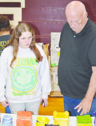 Seventh-grader Kinzlee Depew, left, with her papa, Gene Gable, goes over some of the art at the recent Clinton Middle School Art Fair. CDN | Michael Maresh