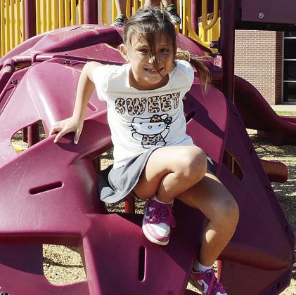 Kiya Lime climbs down the jungle gym at Southwest Elementary School. CDN | Sam Goodwyn