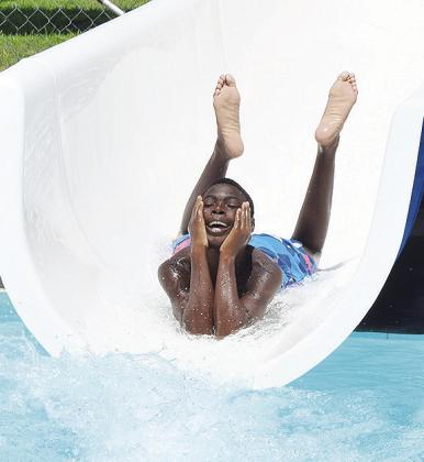 Tylain Rainge is all smiles as he rides the down the water slide Wednesday at the Clinton Municipal Pool. The pool will be closing soon. CDN | Sam Goodwyn