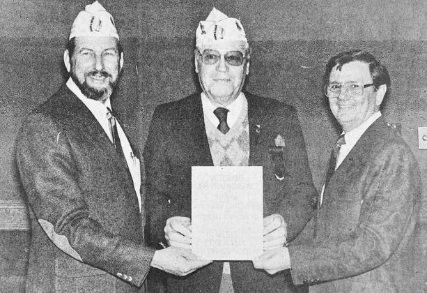 40 YEARS AGO August Reuber, department service officer and member of American Legion Post 41 of Clinton, center, received the “Veterans’ Job Training Act” logo from Phil Boatner, department commander of the American Legion, left, and Bill Pearson, d