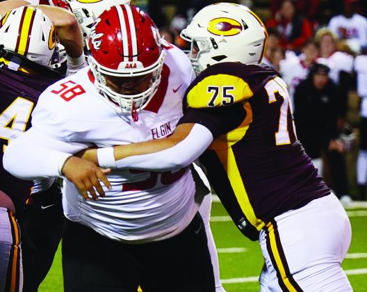 Clinton’s No. 75 Eli Anderson blocks the Elgin defender during the Red Tornadoes’ homecoming game Friday against the Owls in the Tornado Bowl. CDN | Micah Ashcraft