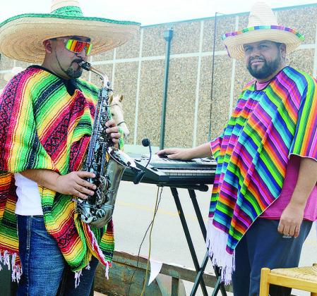 Jesus Martinez, left, plays saxophone, while Jesus Mendoza plays the keyboard at Friday’s Cinco de Mayo Parade CDN | Michael Maresh