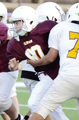 Braxtyn Taylor fights through Chase Spottedwolf’s block during their Clinton NEXT League football game Tuesday at the Tornado Bowl. CDN |Sam Goodwyn