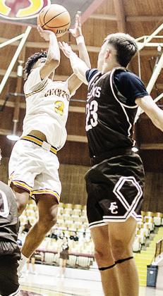 No. 3 Titan Malone rises above the Elk City defender Saturday to shoot the ball in Clinton’s basketball game. CDN | Sam Goodwyn