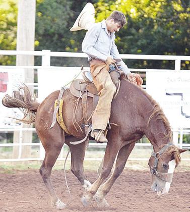 Wyatt Graves holds onto his horse as he loses his hat in the saddle bronc riding event Saturday during the Clinton Roundup Club’s 78th Annual Rodeo. CDN | Sam Goodwyn