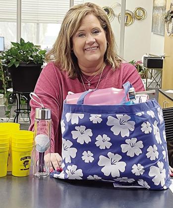 Clinton Chamber of Commerce President Julie Caldwell shows some of the giveaways to travelers in an effort to get them to stop in Clinton. CDN | Michael Maresh