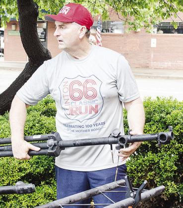 David Davis sets up equipment prior to the start of this year’s edition of the Clinton Classic Run on Frisco Avenue.