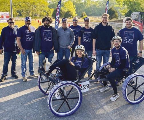 SWOSU Rover Dawgs pose with their human-powered rover at NASA’s Human Exploration Rover Challenge. From left are Brett Chase, Nathan Brooks, Tomas Izquierdo, Mason Pritchard, Brandon Ogle, Caden Tucker, Justin Wiersema, and Kamryn Brewer; seated, Ana Ar