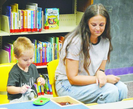 Carter Bogdan, left, is building a boat as Madison Cookerly is there to help in case he needs it at the Clinton Public Library. CDN | Christian Jacobsen
