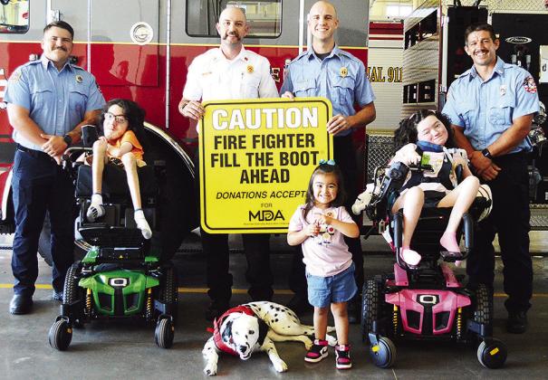 Front from left, Joshua Sorter, Raylee Flores, and Emery Sorter; back, Austin Long, Capt. DJ Woodall, Lt. Tyler Calvert, and Alex Tyler at the Clinton Fire Department prepare for the annual “Fill the Boot” fundraiser to fight muscular dystrophy diseas