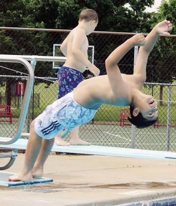 Juan Martinez tries to perform a backflip into the water Thursday at the Clinton Pool during Summer Playground. CDN | Christian Jacobsen