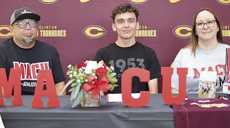 Clinton’s Xadrian Hernandez, center, celebrates Friday with his stepfather Rocky Rodriquez, left, and mother Crystal Munsey Rodriquez, right, after signing to run for Mid-America Christian University track and field, and cross country teams next year. C