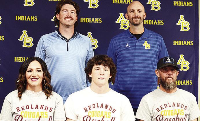 Arapaho-Butler’s Rylan Moore, center, celebrates signing to play baseball for Redlands college in El Reno. Pictured in front, from left, are his mom Meagan Moore, and his dad Joey Moore; back, Coach Chase Johnson and Coach Bryan Holt. CDN | Sam Goodwyn