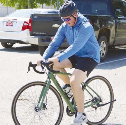 Gavin Evans rides his bike on the walking trail at Acme Brick Park. CDN | Christian Jacobsen