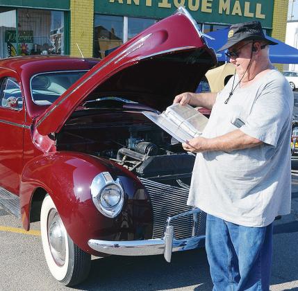 Orval Williams shows off the documentation of all the vehicle registrations for his 1940 Mercury 8 Saturday at the Centennial Lap event on Frisco Avenue. More pictures from the event are on page 16. CDN | Christian Jacobsen