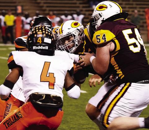 Clinton’s No. 54 Brayden Fuller pushes quarterback Easten Powell to help him gain yards against Douglass defenders during the Red Tornadoes’ home game Friday against the Trojans. CDN | Micah Ashcraft