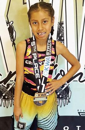 Adelynn Lonebear smiles after finishing fifth in the 8U 47-pound class during the OKWA State Wrestling Tournament in Oklahoma City over the weekend. CDN |Courtesy Photo