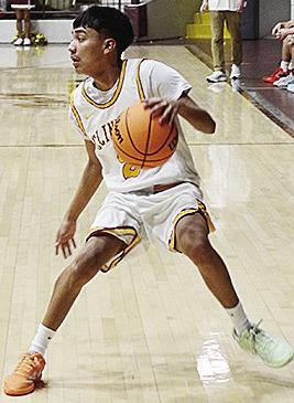 Clinton’s Ronnie Redshin looks for an open teammate as he drives the ball up the court in the game Tuesday against Woodward. CDN | Sam Goodwyn