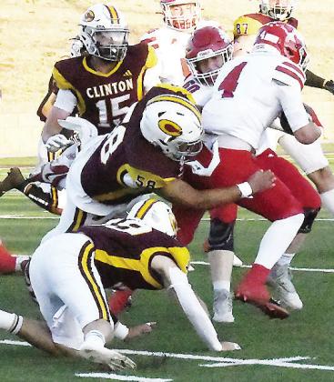 Clinton’s No. 58 Ares Gallegos takes down the Durant ball carrier while No. 19 Dyson Moss and No. 15 Gavin Evans come to help during the Red Tornadoes’ come-from-behind win Friday in the Tornado Bowl. CDN | John Kinsey