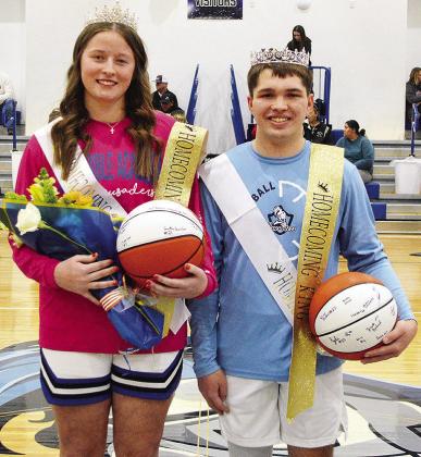 Kate Stewart, left, and Zack Zyback stand together at center court after being recognized as the Corn Bible Academy Basketball Homecoming Queen and King just before tip-off Thursday night. CDN | Micah Ashcraft