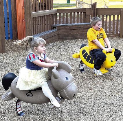 Marjury and Phoenix Sandoval were the first to ride some of the new playground equipment that arrived at the M.T. and Helen Gholston Children’s Park at Acme Park last week. The new features in the small kids’ area were paid for with money donated to t