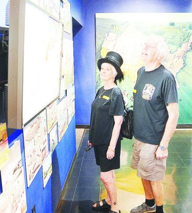 Lynn Partridge-Webber, left, and her husband Roger examine an exhibit at the Oklahoma Route 66 Museum while they take a trip down the Mother Road while visiting from the UK. CDN | Sam Goodwyn
